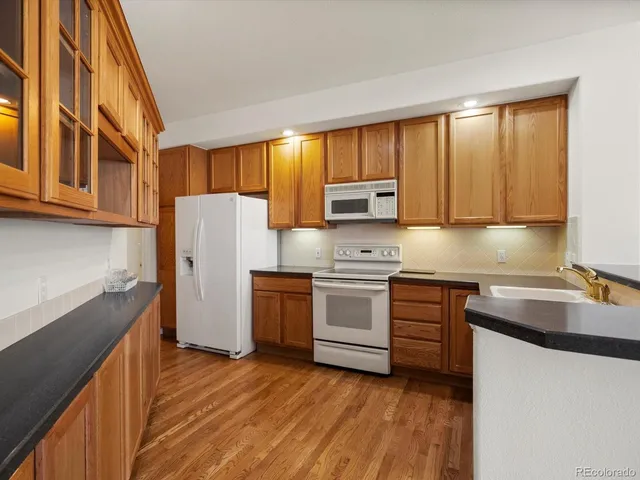 a kitchen with a sink cabinets stainless steel appliances and a window