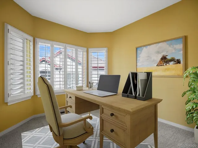 a view of a dining room with furniture and windows