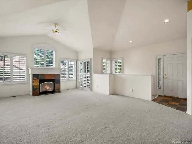 an empty room with furniture and a fireplace