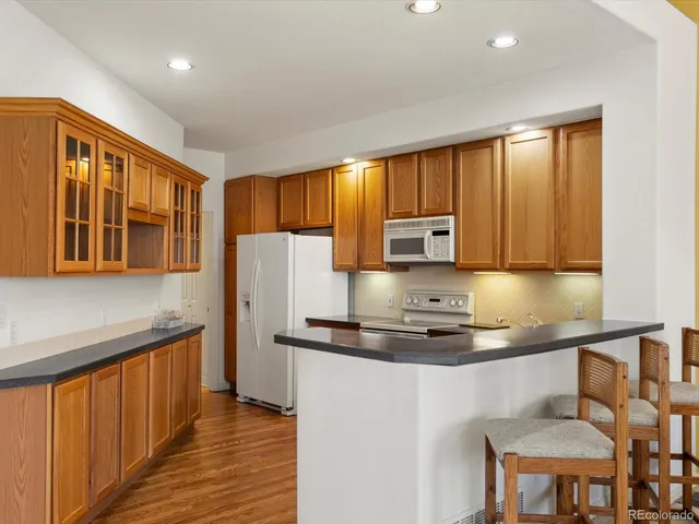 a kitchen with a refrigerator and a stove top oven