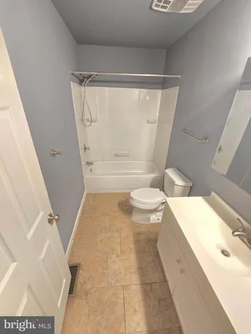 a bathroom with a tub toilet and sink
