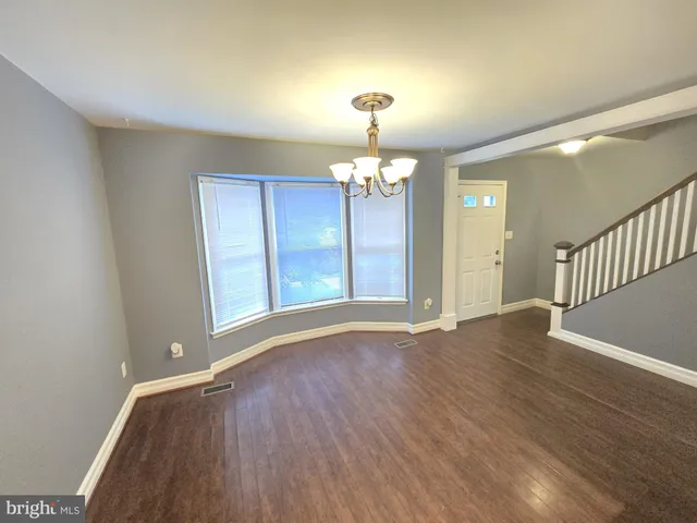 a view of livingroom with chandelier and wooden floor