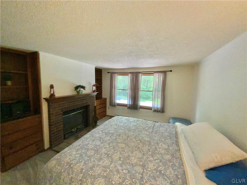 419 Merwinsburg Road Effort, PA 18330 - Photo 14 of 32 a bedroom with a bed and a dresser