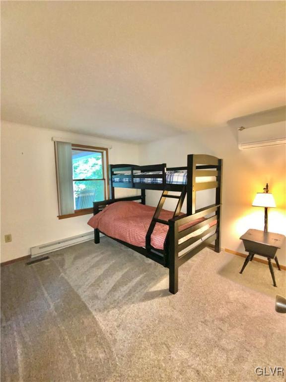 419 Merwinsburg Road Effort, PA 18330 - Photo 16 of 32 a bedroom with a bed and a table in it