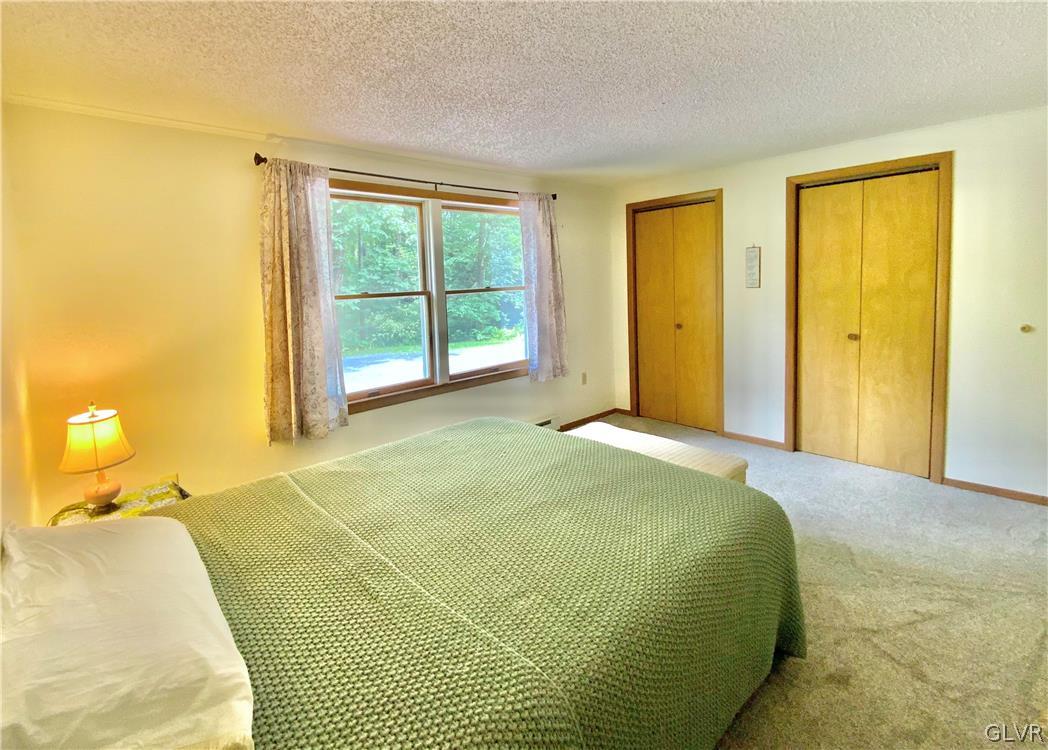 419 Merwinsburg Road Effort, PA 18330 - Photo 19 of 32 a bedroom with a bed and a window