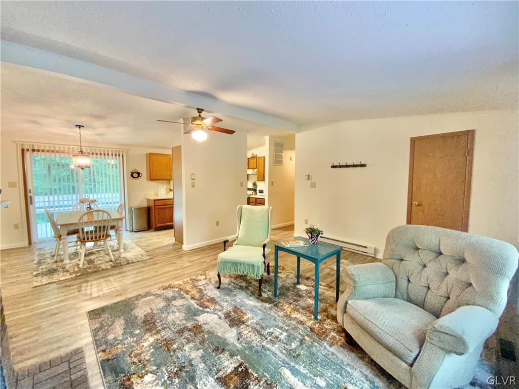 419 Merwinsburg Road Effort, PA 18330 - Photo 6 of 32 a living room with furniture and a dining table with kitchen view