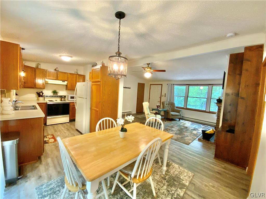 419 Merwinsburg Road Effort, PA 18330 - Photo 7 of 32 a very nice looking dining room with a table chairs and a kitchen view