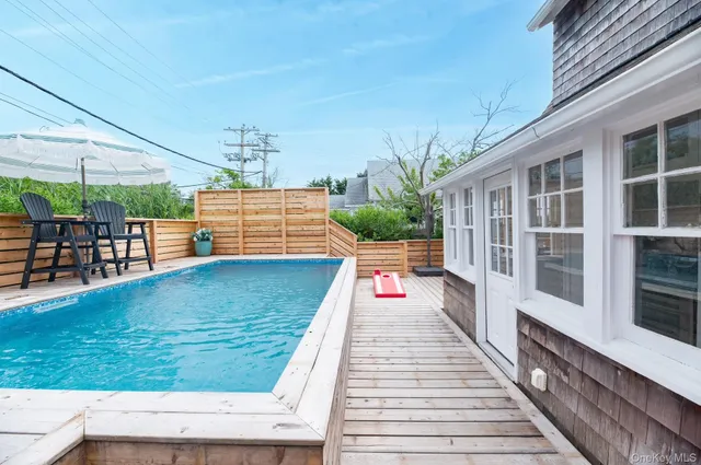 a front view of a house with outdoor seating