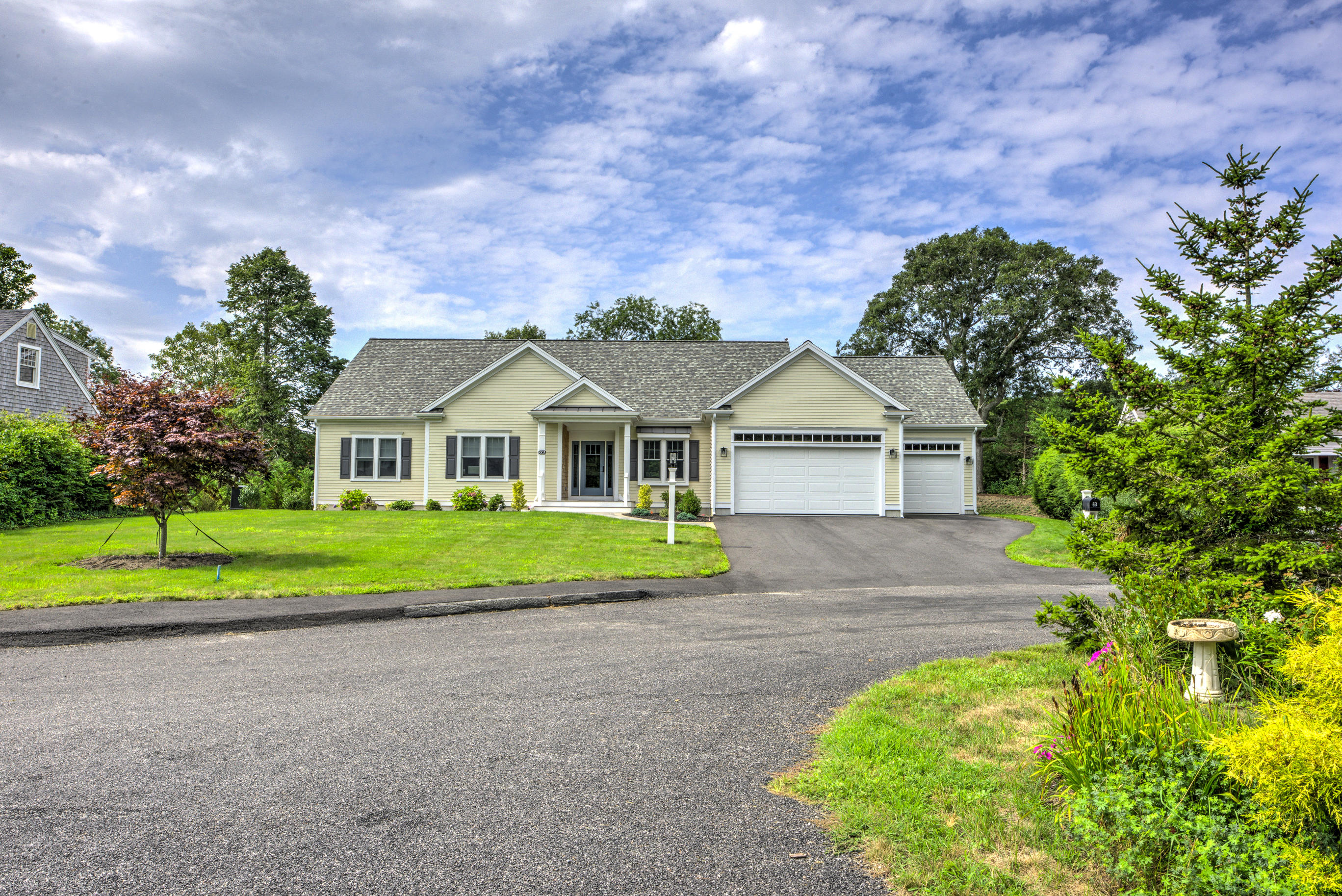 63 Joyce Anne Road Centerville, MA 02632 - Photo 1 of 35 a front view of a house with a yard and garage