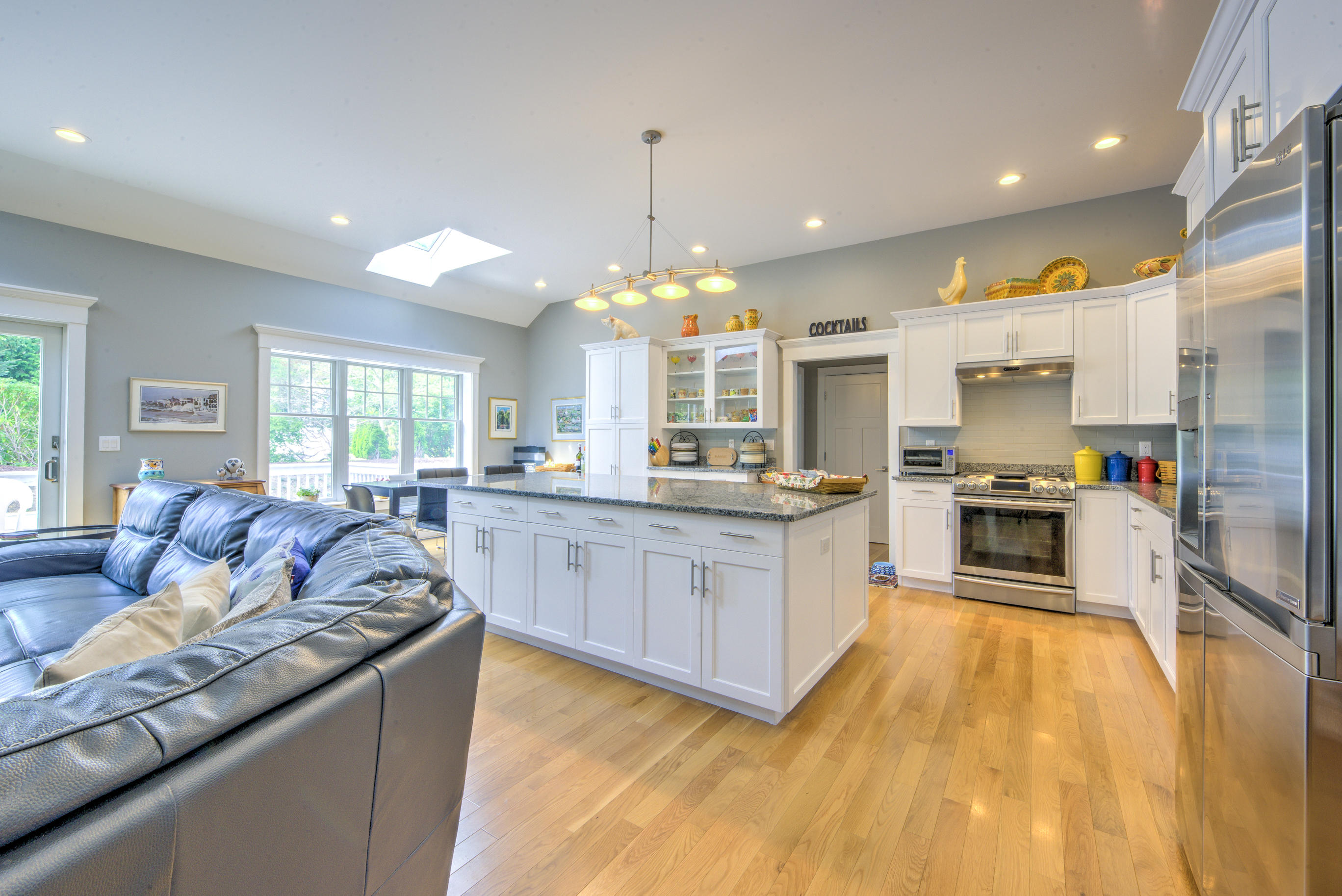 63 Joyce Anne Road Centerville, MA 02632 - Photo 11 of 35 a large kitchen with granite countertop a large counter top stainless steel appliances a window and cabinets