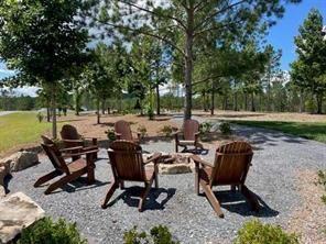 135 Twisted Oak Road Talking Rock, GA 30175 - Photo 23 of 27 a view of a backyard with chairs potted plants and a large tree
