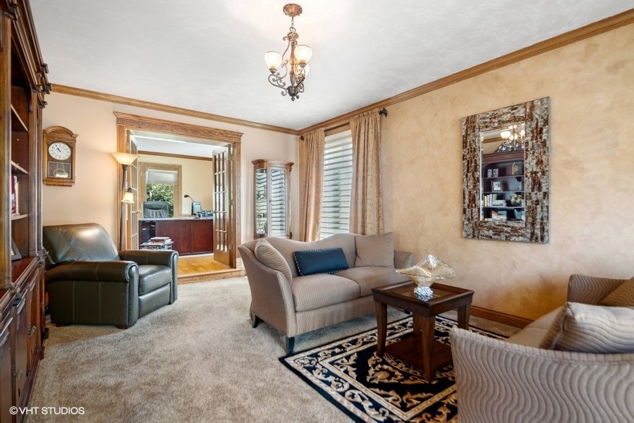 467 81st Street Burr Ridge, IL 60527 - Photo 12 of 45 a living room with furniture and a chandelier