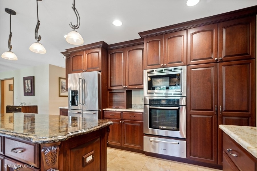 467 81st Street Burr Ridge, IL 60527 - Photo 18 of 45 a kitchen with stainless steel appliances granite countertop a refrigerator a stove and a sink with wooden floors