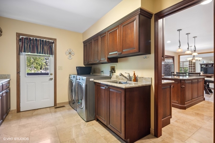 467 81st Street Burr Ridge, IL 60527 - Photo 21 of 45 a kitchen with stainless steel appliances granite countertop a stove top oven a sink a counter space and cabinets