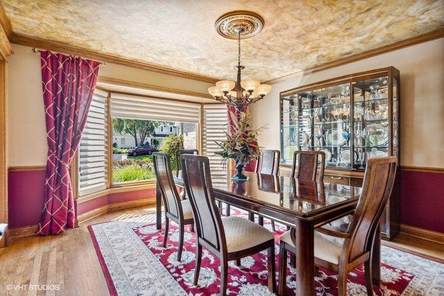 467 81st Street Burr Ridge, IL 60527 - Photo 23 of 45 a dining room with furniture a chandelier and wooden floor