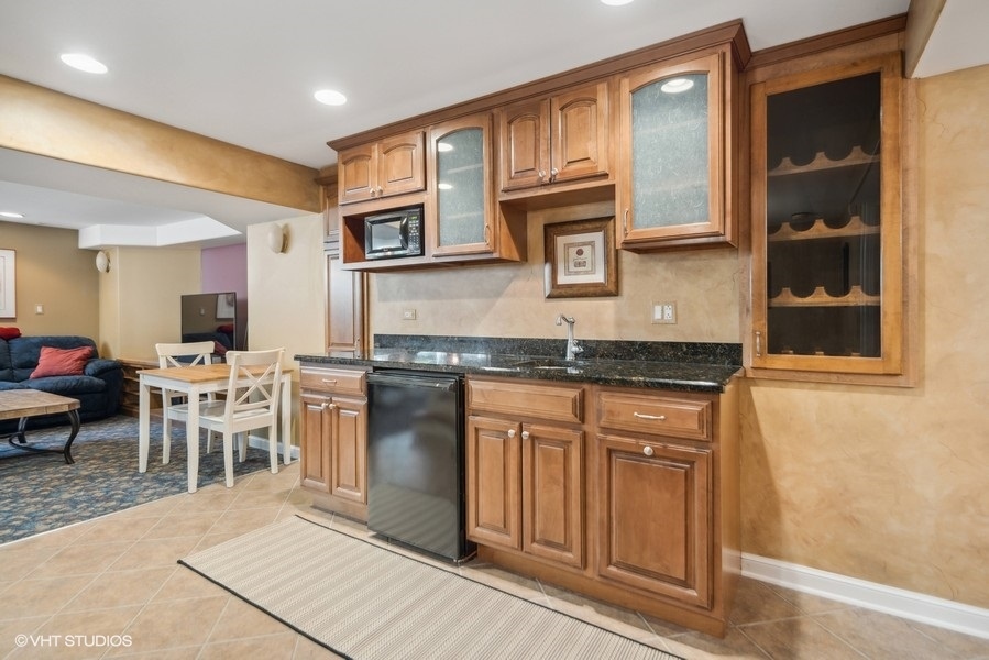 467 81st Street Burr Ridge, IL 60527 - Photo 33 of 45 a kitchen with stainless steel appliances granite countertop a stove a sink and a microwave