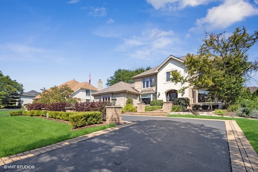 467 81st Street Burr Ridge, IL 60527 - Photo 4 of 45 a view of a white house with a yard and plants