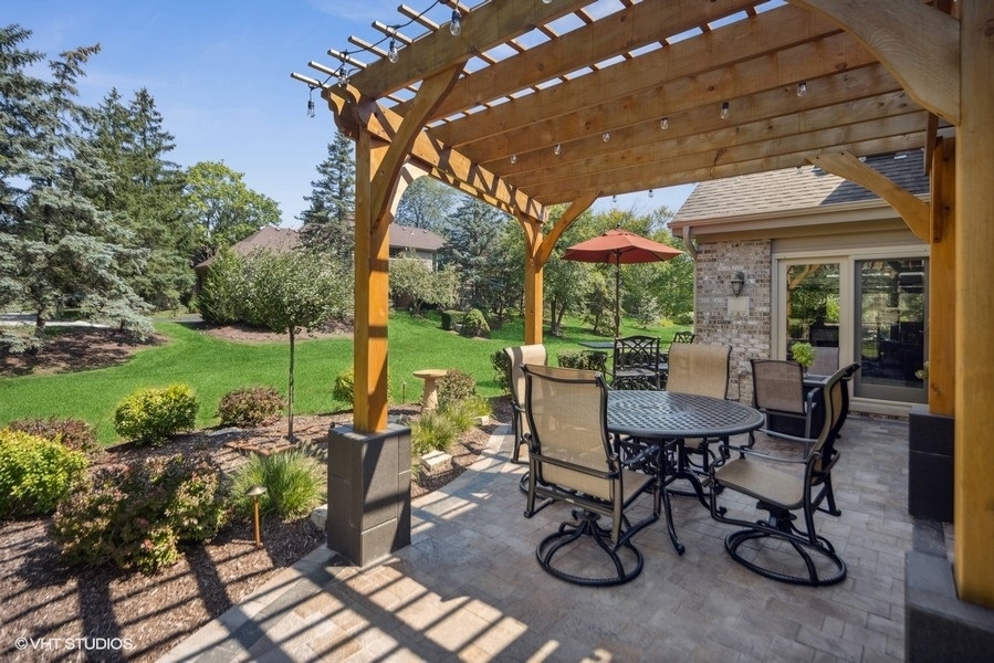 467 81st Street Burr Ridge, IL 60527 - Photo 41 of 45 a view of a patio with table and chairs potted plants and a large tree