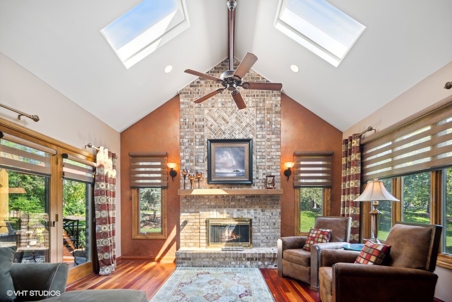467 81st Street Burr Ridge, IL 60527 - Photo 8 of 45 a living room with furniture a fireplace and a floor to ceiling window
