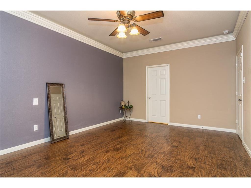 1009 Hawthorne Road Anna, TX 75409 - Photo 15 of 22 Spacious room featuring wood-finish flooring, crown molding, and a ceiling fan with integrated lighting