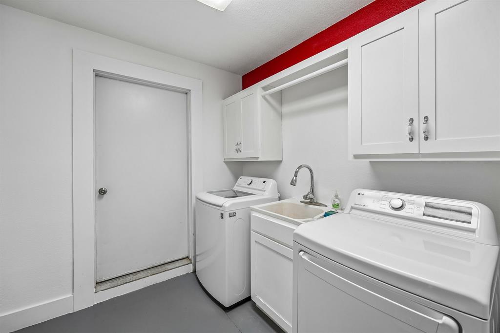 331 Radecke Road Krum, TX 76249 - Photo 24 of 40 Laundry area featuring white cabinetry, utility sink with chrome faucet, and a hanging rod