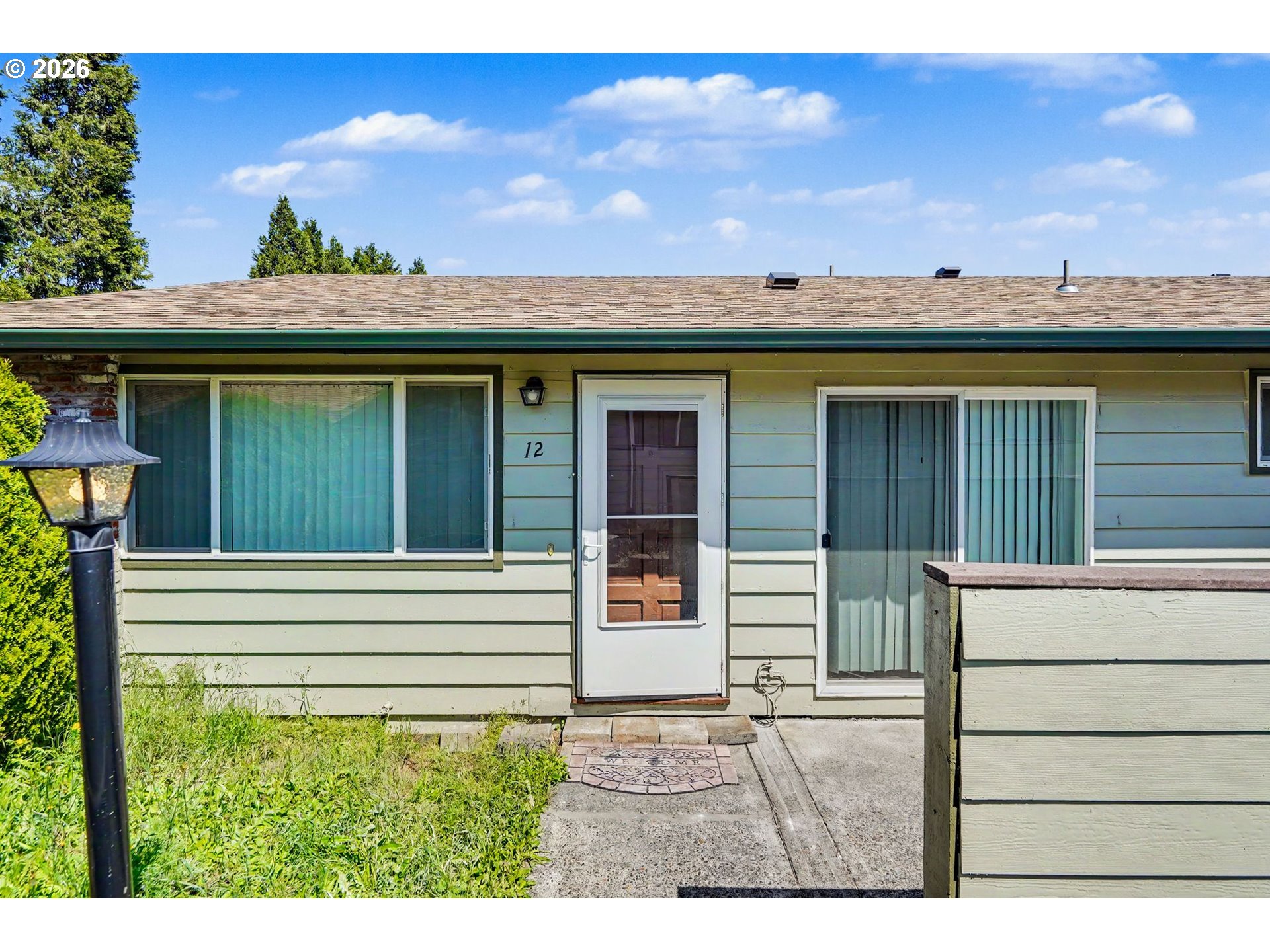 777 Boone Road Southeast, Unit 12 Salem, OR 97302 - Photo 1 of 16 a view of a house with a window and a yard
