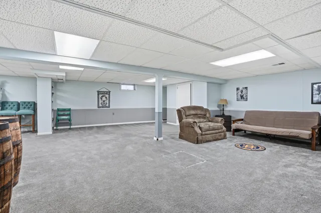 a living room with furniture a window and a fireplace