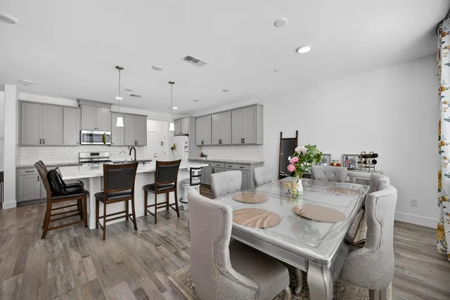 a kitchen with sink cabinets and wooden floor