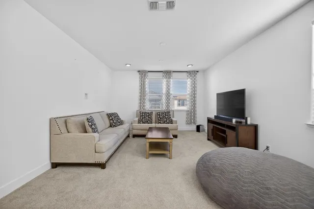 a bedroom with a bed and a mirror