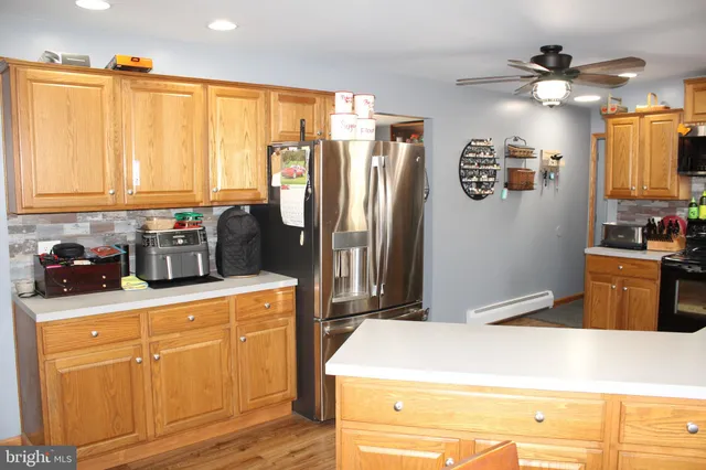 a kitchen with granite countertop a sink a stove and cabinets