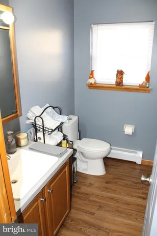 a bedroom with a bed and a mirror on the dresser