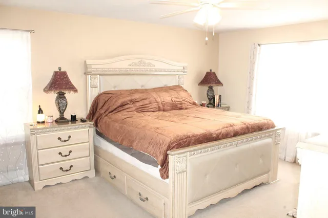 a bedroom with a bed and a dresser in it