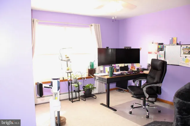 a bedroom with a bed a flat screen tv and a chandelier