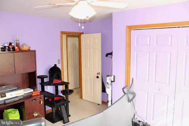 a bedroom with a bed dresser and a large mirror