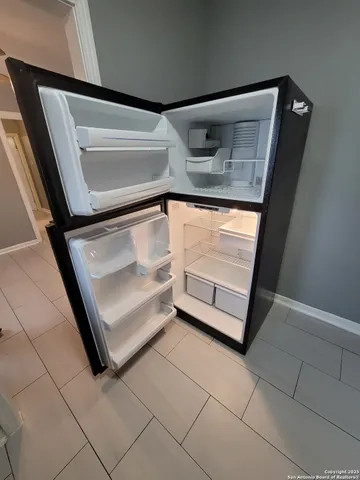 a kitchen with a sink dishwasher and a refrigerator