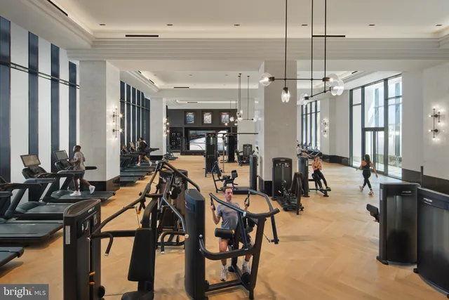 a view of a room with lots of chairs and mirrors