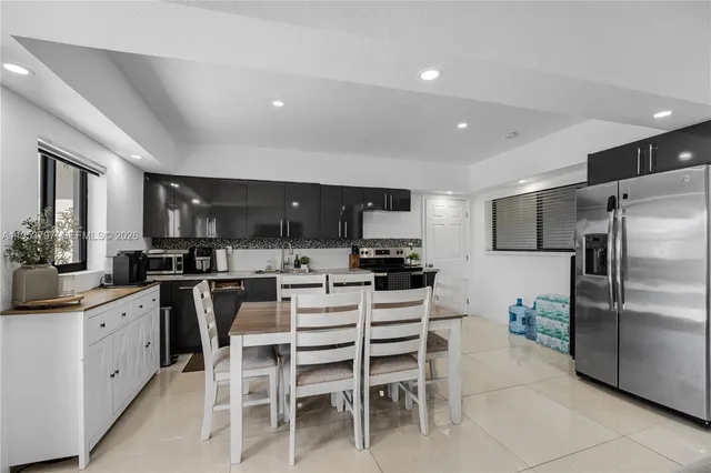 a kitchen with a sink stainless steel appliances and cabinets