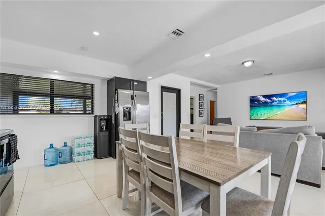 a dining room with furniture and window
