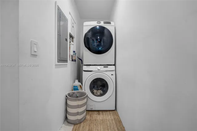 a utility room with sink dryer and washer