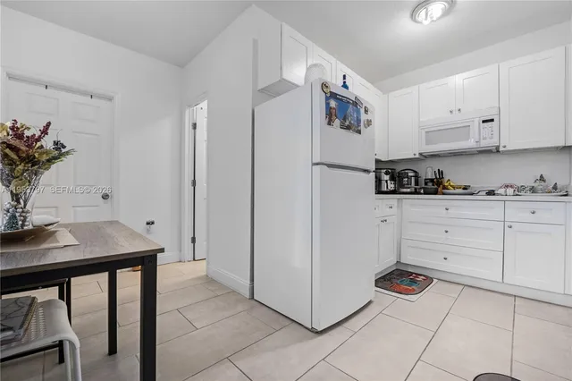 a kitchen with a refrigerator and cabinets