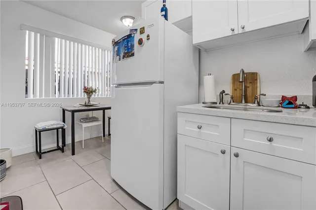 a kitchen with cabinets and window