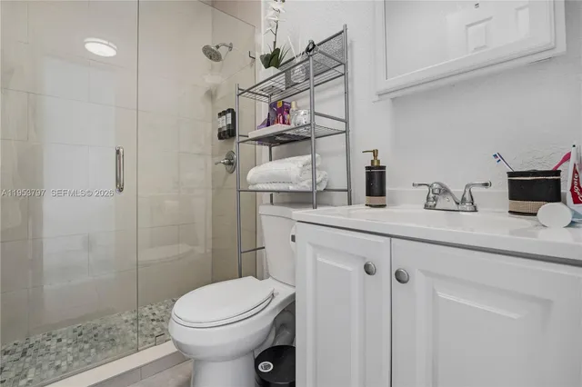 a bathroom with a sink toilet and shower