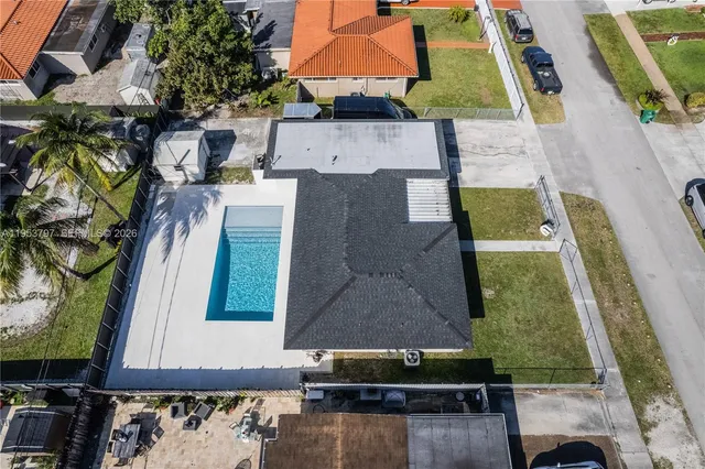 an aerial view of residential houses with outdoor space