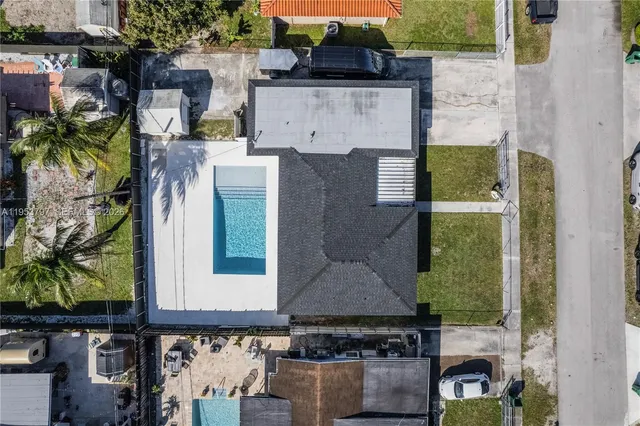 an aerial view of a house with a yard