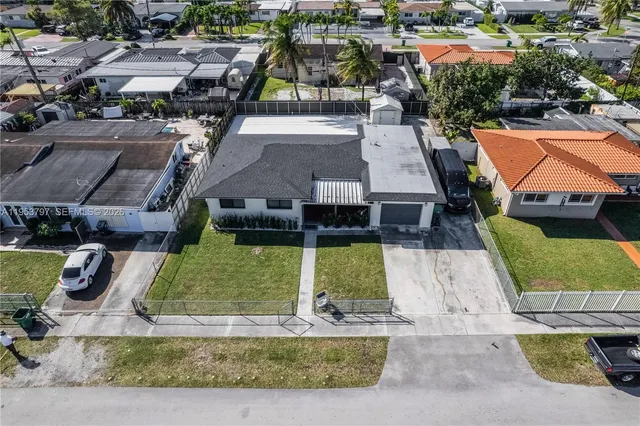 an aerial view of houses with outdoor space