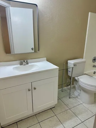 a bathroom with a sink vanity and toilet
