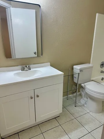 a bathroom with a sink vanity and toilet