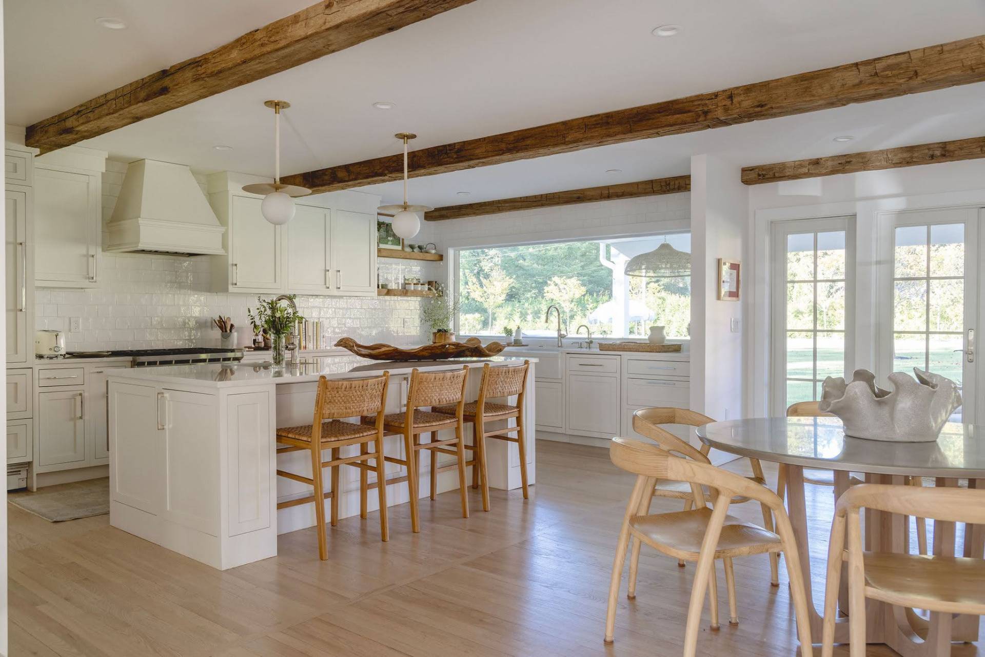 29 Maple Lane East Hampton, NY 11937 - Photo 3 of 44 a kitchen with stainless steel appliances granite countertop table chairs and wooden floor