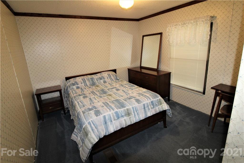 241 Gateway Farm Road Clover, SC 29710 - Photo 14 of 19 a bedroom with a bed and a mirror