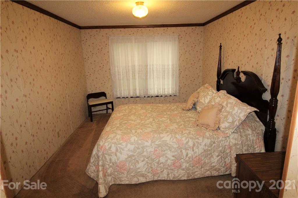 241 Gateway Farm Road Clover, SC 29710 - Photo 7 of 19 a bed sitting in a bedroom next to a window